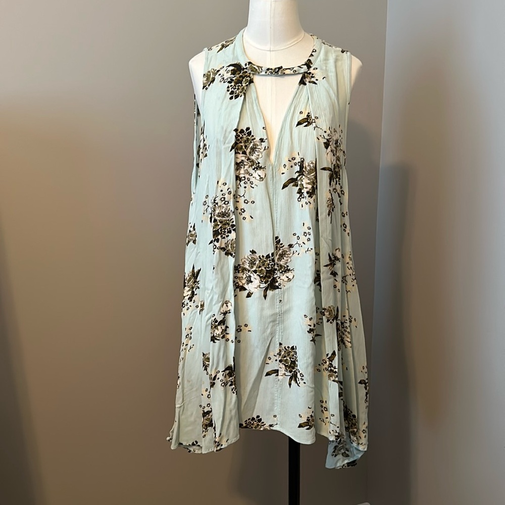 Free people sleeveless top , small, longer in back, mint in color with floral